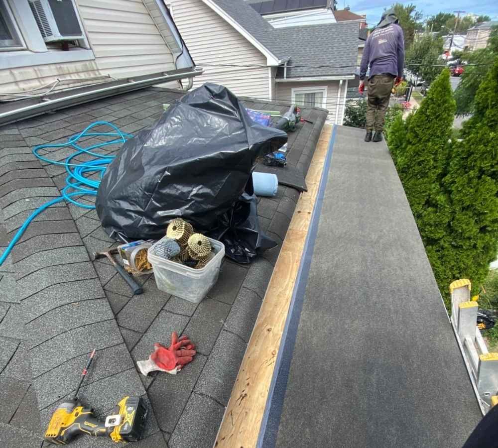 High quality professional commercial and residential roofing repair work in Bronx New York, professional roofer inspecting architectural asphalt shingles on an urban residential home with clean safety gear, overcast bright daylight, crisp architectural photography